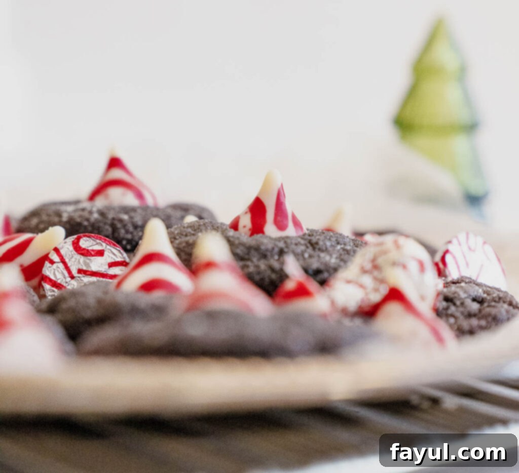 Beautifully arranged Peppermint Kiss Chocolate Cookies with a recipe overlay