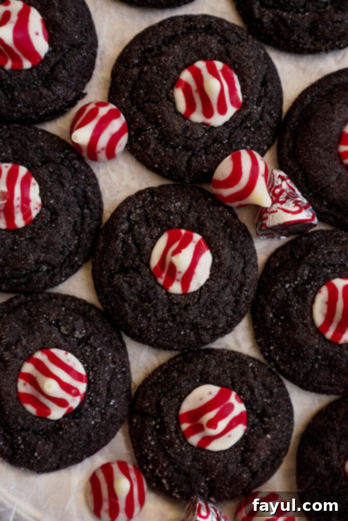 Process of adding a peppermint kiss to a warm chocolate cookie