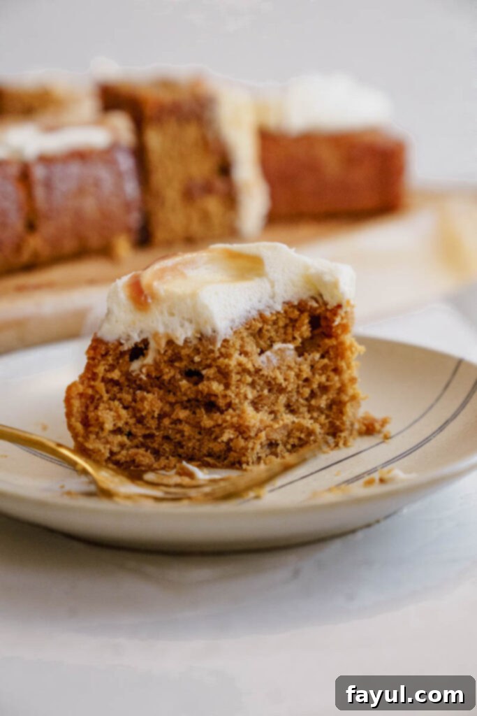 Overhead view of a Caramel Gingerbread Cake with a generous layer of cream cheese frosting and homemade caramel
