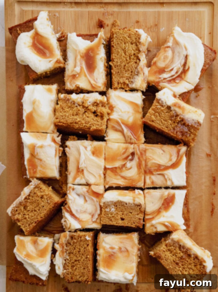 A close-up of a frosted cake being topped with warm, gooey homemade caramel sauce.