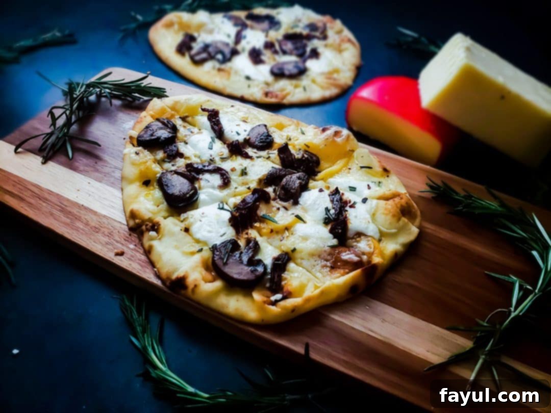This vegetarian flatbread pizza recipe is healthy, easy and fast! The pizza works great as a dinner recipe or as an appetizer. This pizza has three types of cheese, an olive oil based sauce and mushrooms and fresh rosemary!