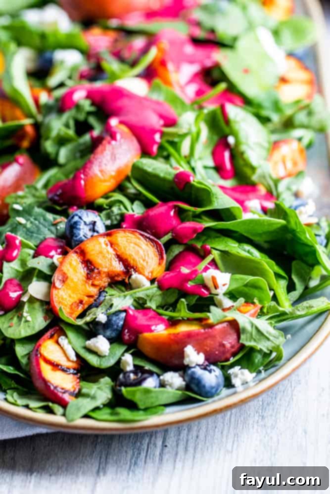 45 degree angle of grilled salad with dressing on top on a platter.