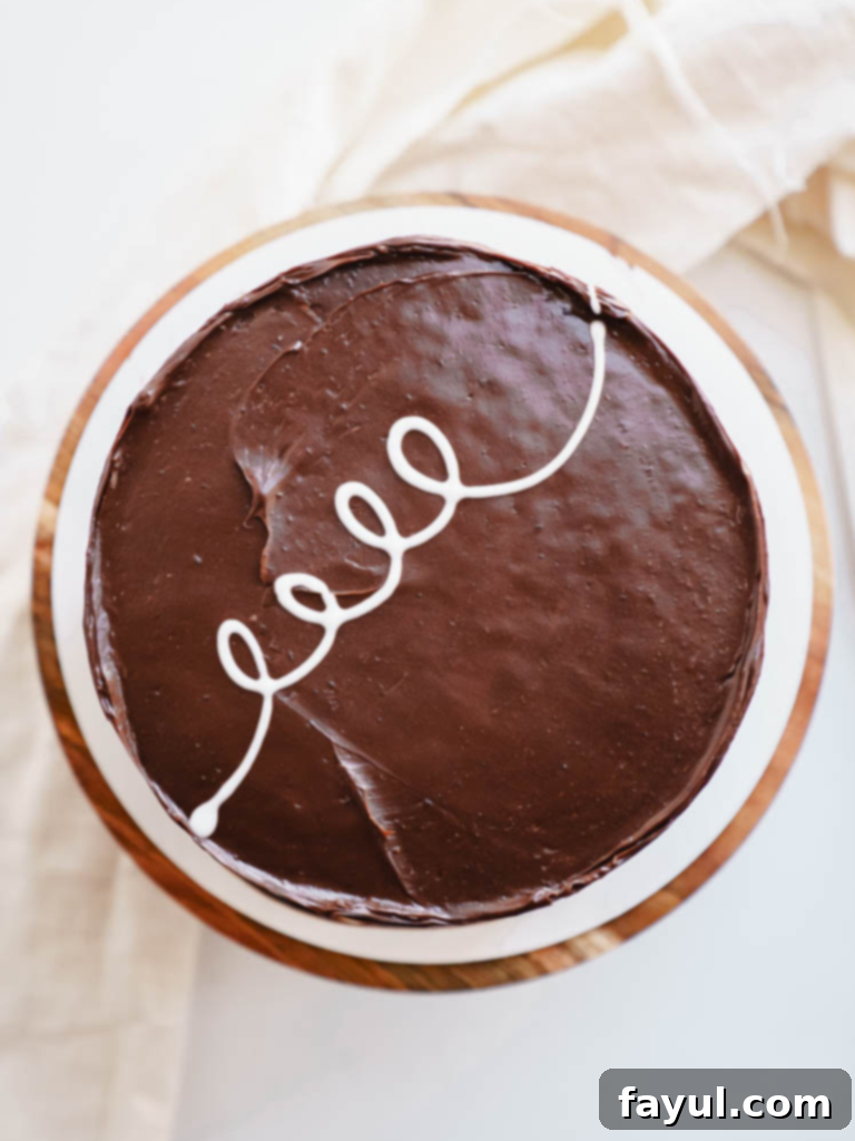 A perfectly sliced homemade Ding Dong Cake revealing the creamy white filling and dark chocolate layers.