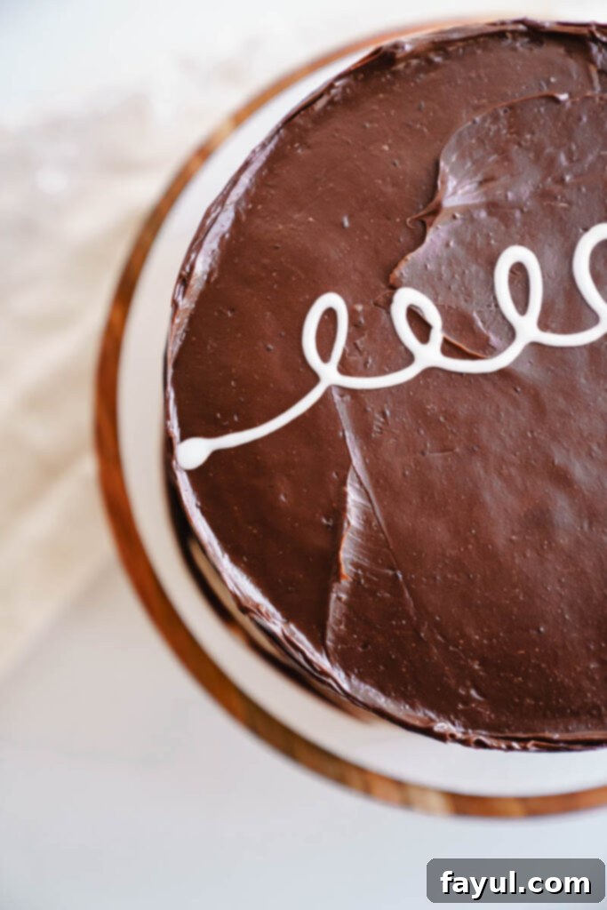 A large piece of homemade Ding Dong Cake, showcasing its beautiful layers and rich frosting.