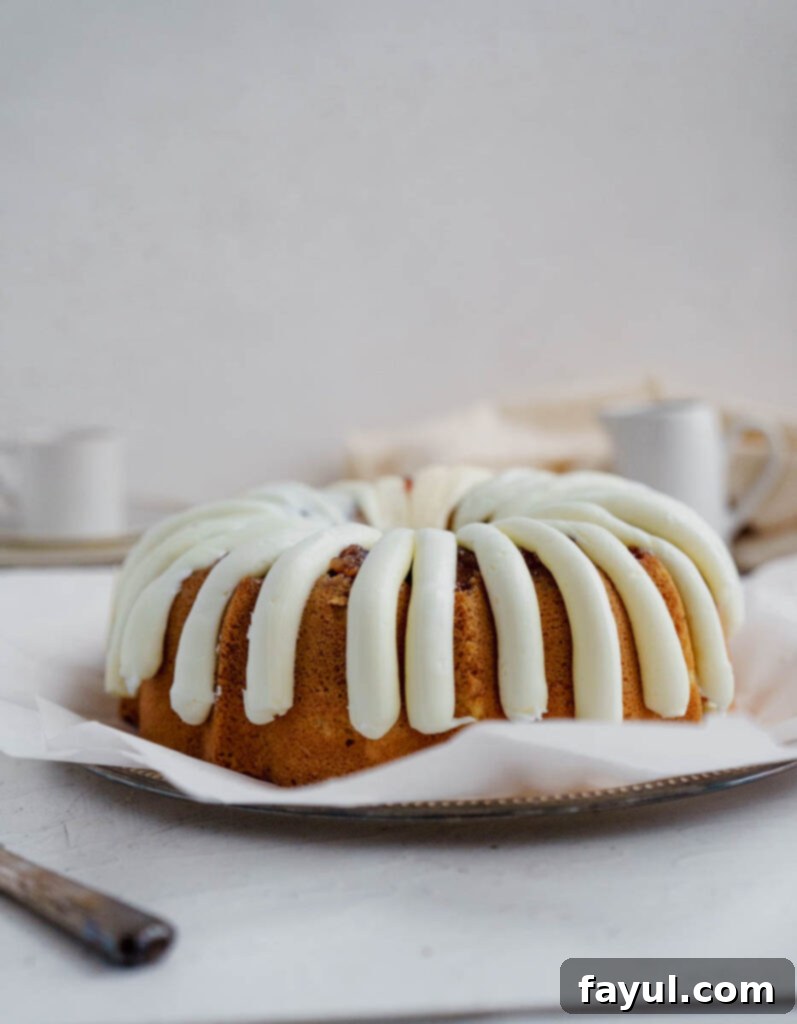 Slice of White Chocolate Raspberry Bundt Cake showing the jam swirl