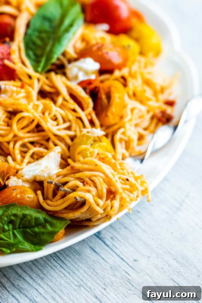 Red pesto pasta twisted elegantly on a silver fork, ready to be enjoyed.