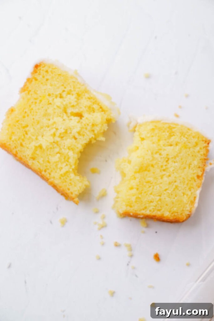 The full lemon loaf cake, freshly baked and glazed, on a cooling rack