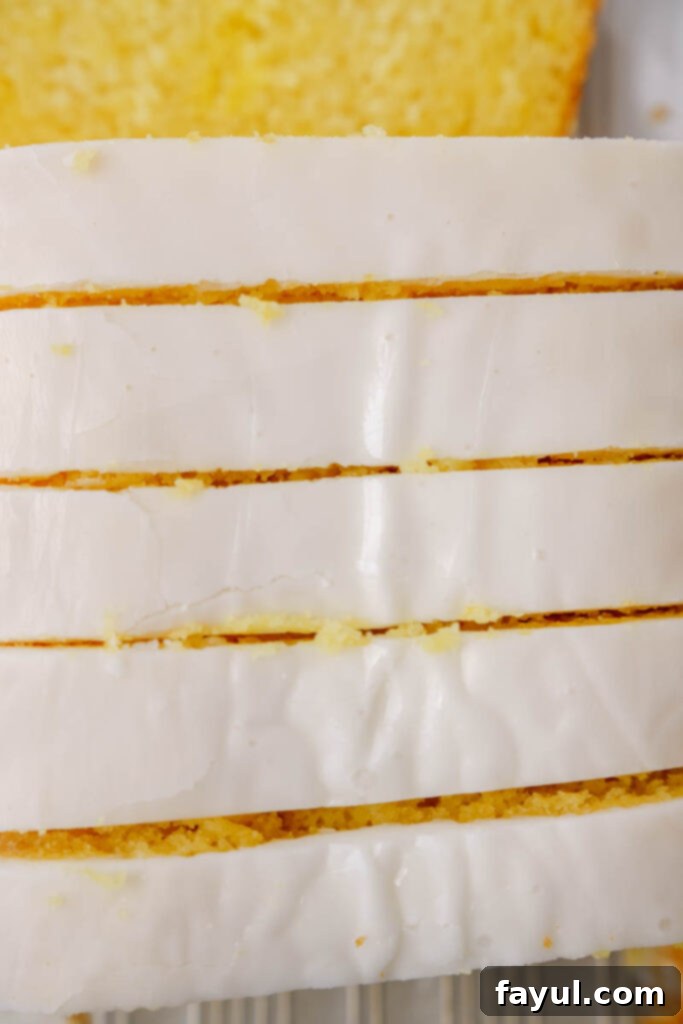 Several slices of lemon loaf cake arranged on a plate, ready to be served