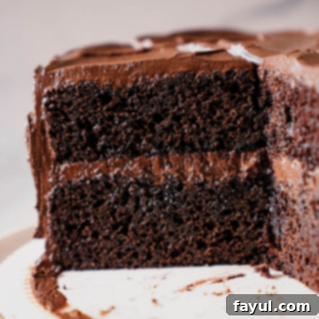 A slice of Portillo's Chocolate Cake with fudgy frosting.