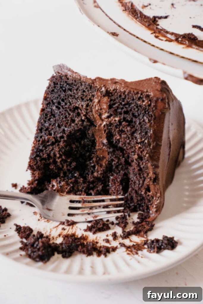 Full Portillo's Chocolate Cake on a cake stand, with a festive decoration.