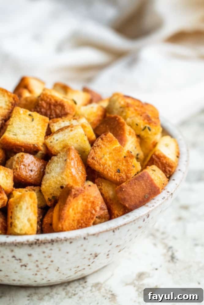 Crispy homemade croutons in a white bowl, ready to be served with soup or salad.