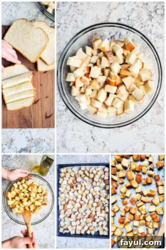 A close-up of bread cubes tossed with olive oil and spices, ready for baking.