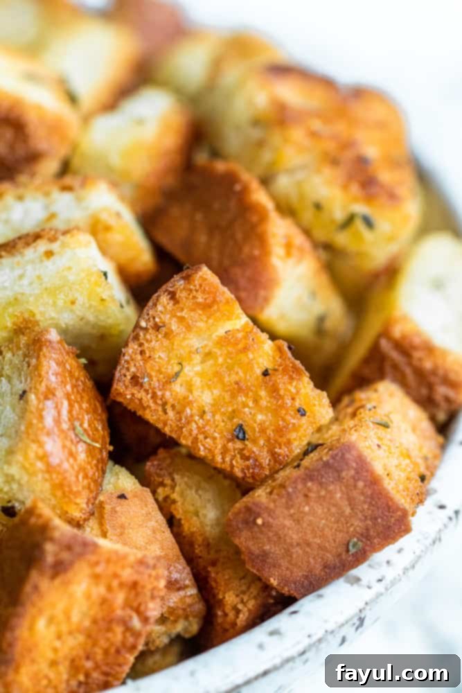 A bowl of fresh homemade croutons with an emphasis on their texture and golden color.