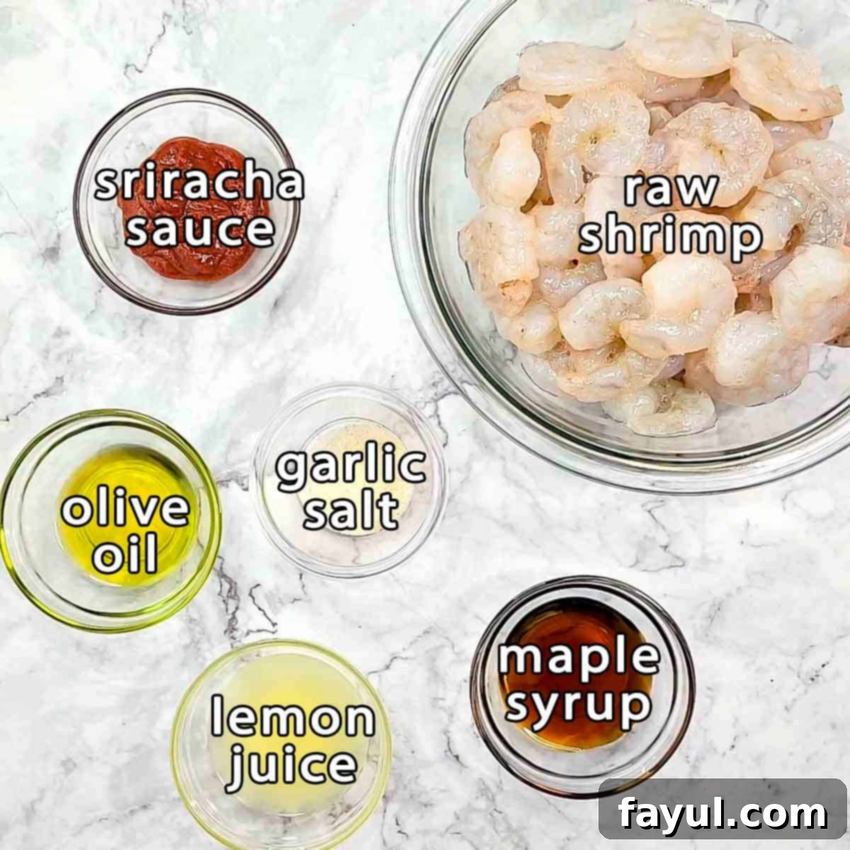 Overhead shot of ingredients - raw shrimp, sriracha sauce, garlic sauce, olive oil, lemon juice, and maple syrup.