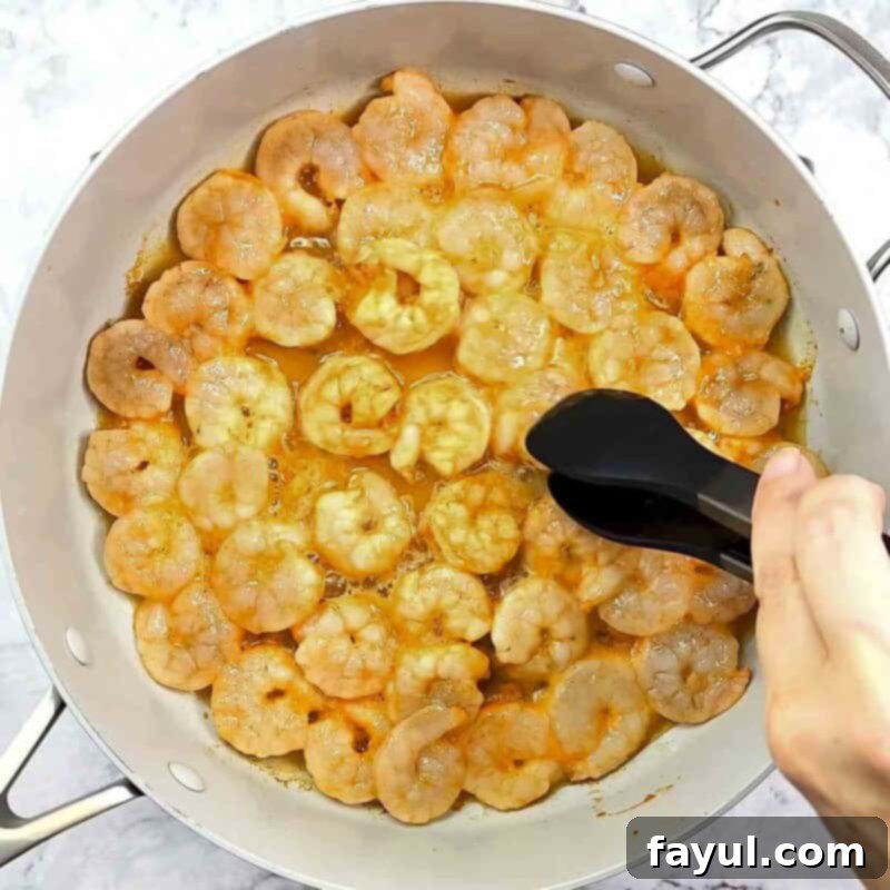 Overhead view of process shot 4 - cook the shrimp 2-3 minutes on each side, until the shrimp become pink and opaque.