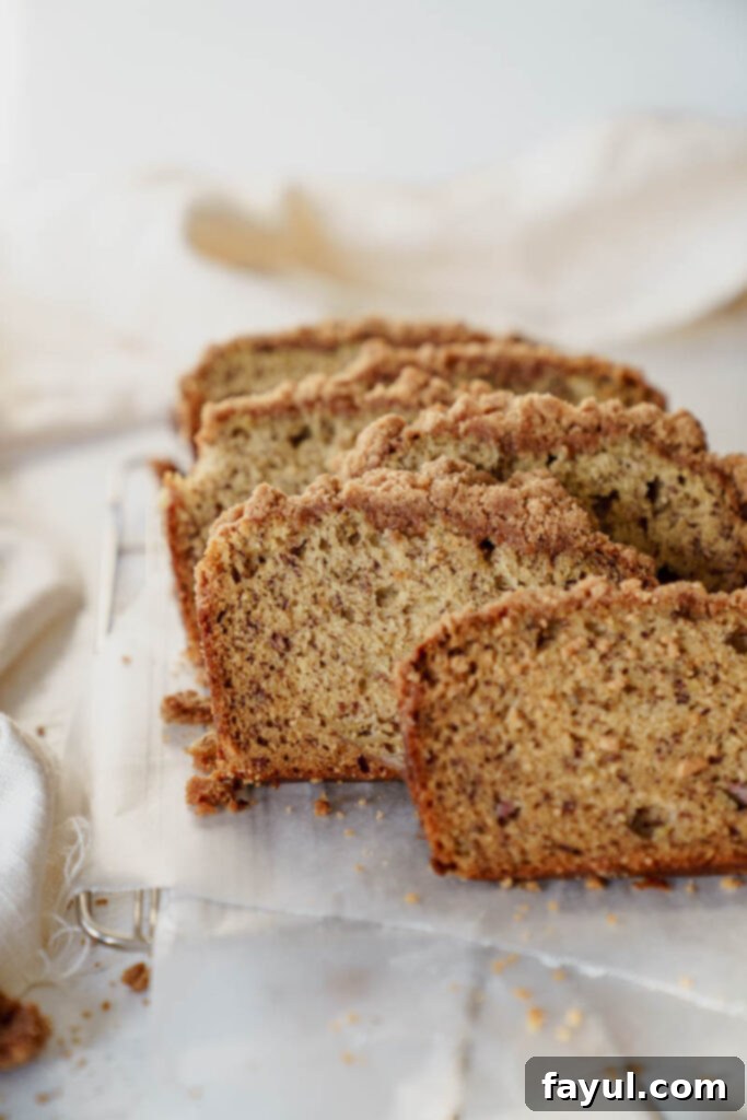 Banana bread batter in a loaf pan with streusel topping