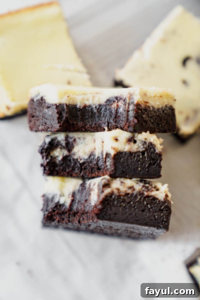 The process of swirling the brownie and cheesecake batters together to achieve a beautiful marbled effect before baking.
