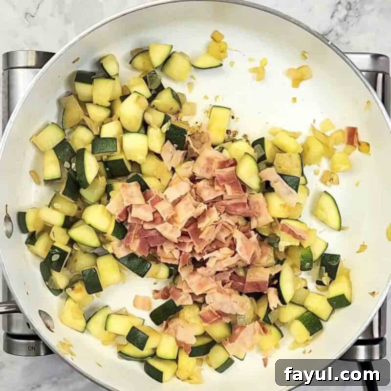 Overhead view of process shot 3 - add the chopped bacon and cook for one more minute with the vegetables.