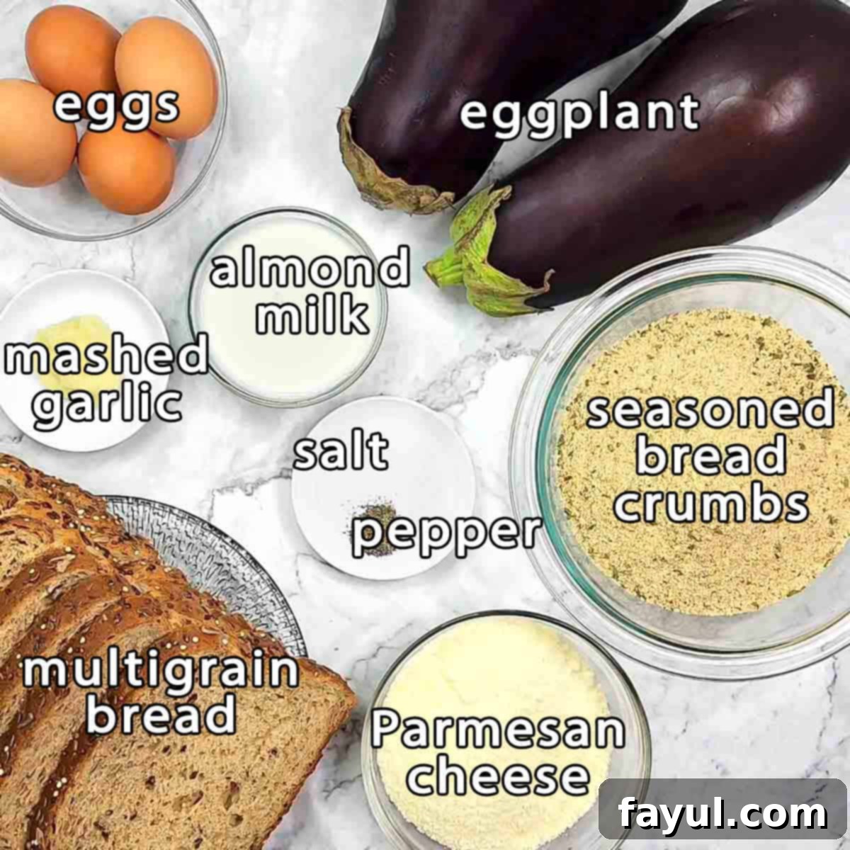 Overhead shot of ingredients for Eggplant Milanese sandwich: eggplant, eggs, almond milk, mashed garlic, seasoned bread crumbs, salt, pepper, parmesan cheese, and multigrain bread.
