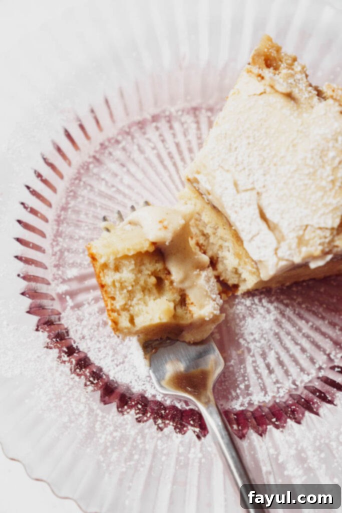 A beautifully sliced portion of Cinnamon Roll Gooey Butter Cake