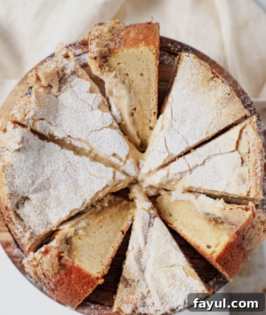 A slice of Cinnamon Roll Gooey Butter Cake being served