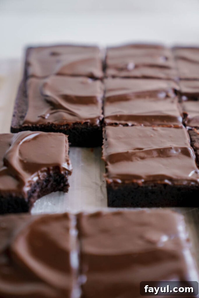 pouring ganache over baked brownies
