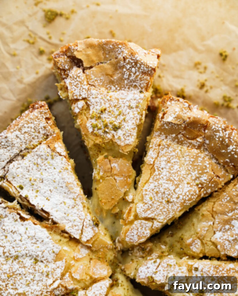 pistachio gooey butter cake with a generous dusting of powdered sugar