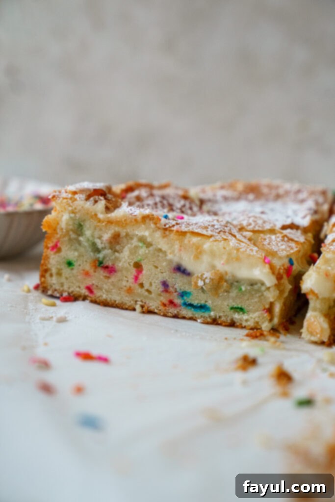 funfetti gooey butter cake sliced in a tray