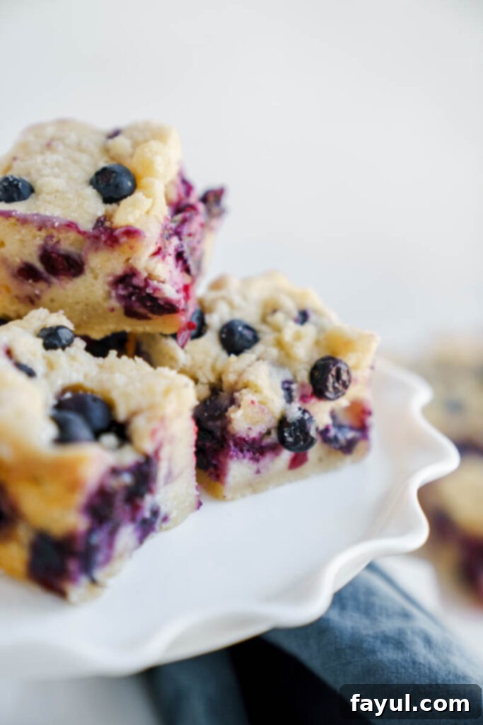 Close-up of a single blueberry pie bar with a creamy filling