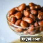 Close up shot of chipotle peanuts in a clear martini glass.