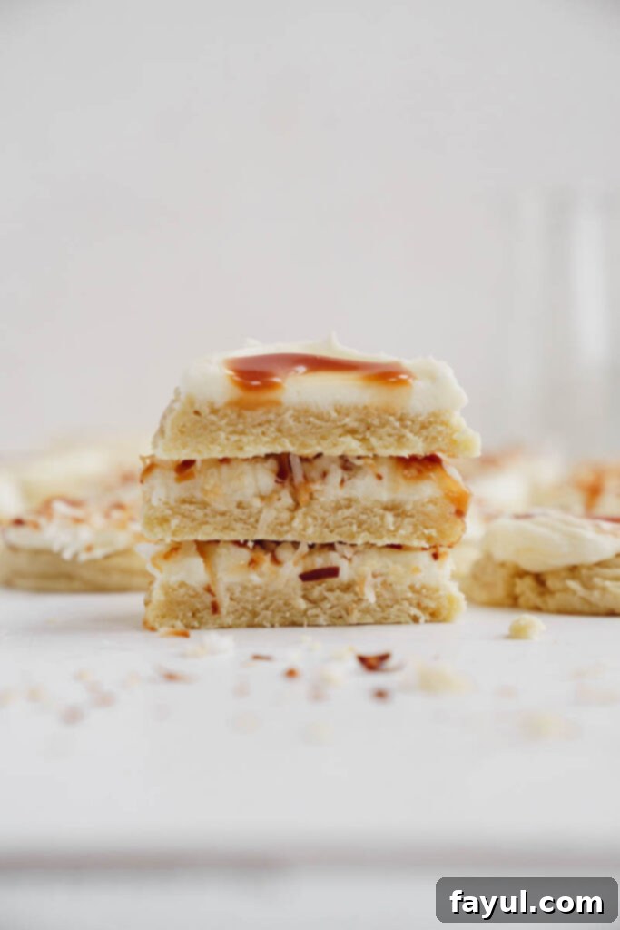 Frosted coconut caramel sugar cookies in a white box, ready for storage