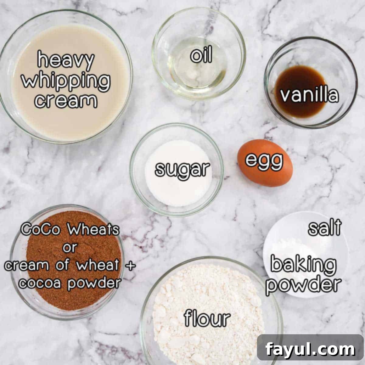 Overhead shot of ingredients - heavy whipping cream, oil, vanilla, sugar, egg, salt, baking powder, flour, and coco wheats (or cream of wheat + cocoa powder).