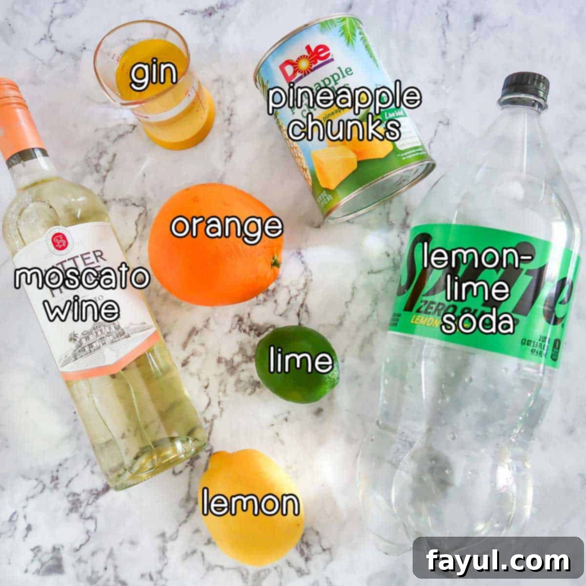 Overhead shot of ingredients - moscato wine, orange, lime, lemon, gin, pineapple chunks, and lemon-lime soda.