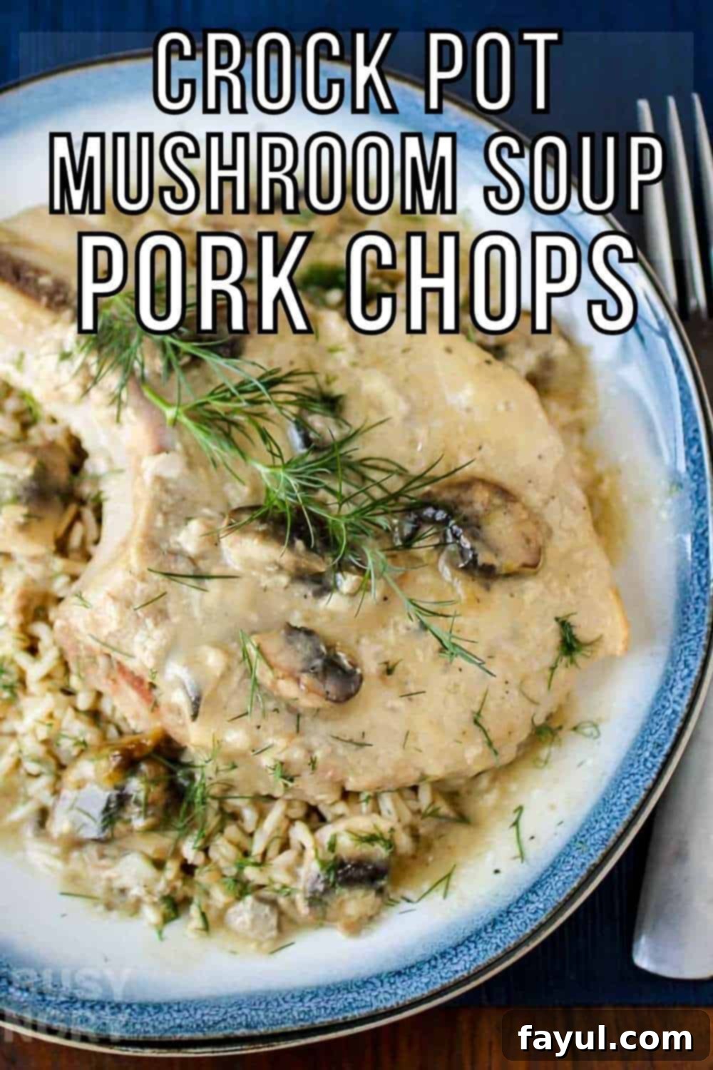 Overhead shot of a pork chop on top of mushroom soup garnished with herbs on a blue and white plate with silverware on the side on a dark blue placemat. Slow cooker pork chops smothered in creamy mushroom soup, ready for a delicious family dinner.