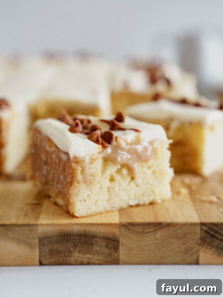 Delicious slice of Cinnamon Roll Poke Cake with cream cheese frosting.