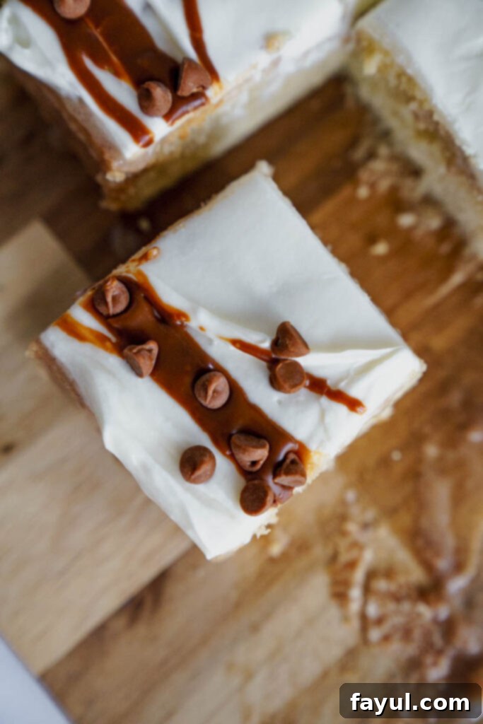 Two slices of Cinnamon Roll Poke Cake on a plate.