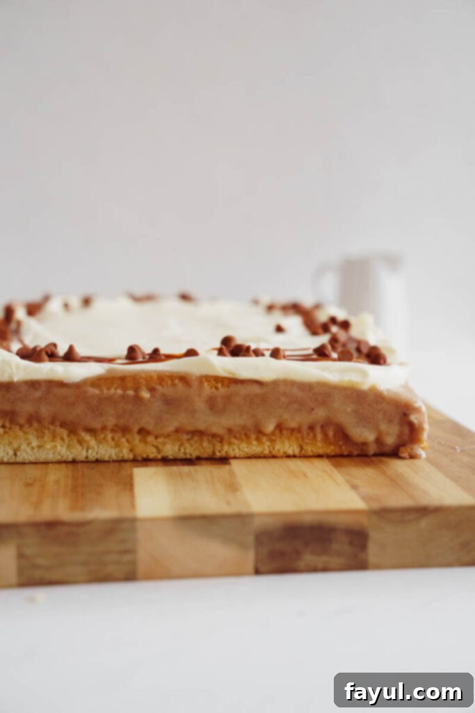 Preparing the Cinnamon Roll Poke Cake with filling.