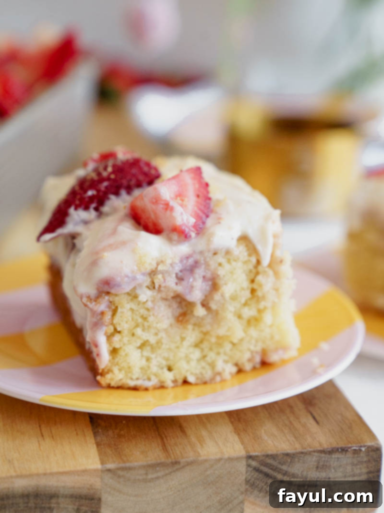 Delicious Strawberry Poke Cake with creamy frosting and fresh strawberries