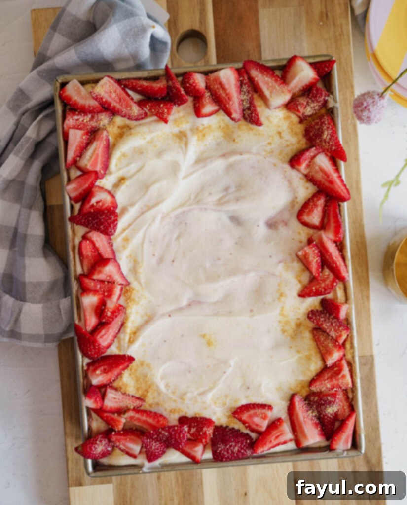 Close-up of a Strawberry Poke Cake after holes have been poked