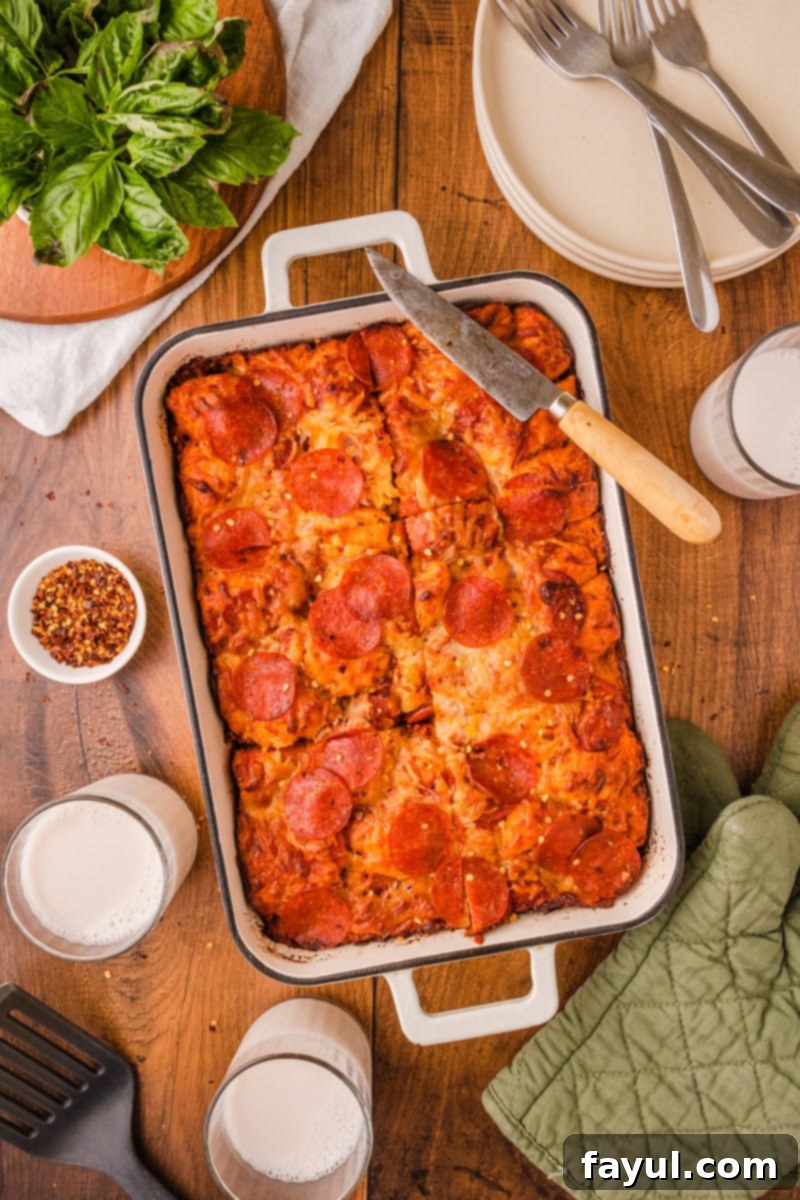 A top-down view of a golden-brown Bubble Up Pizza Casserole, showcasing its bubbly texture and melted cheese.