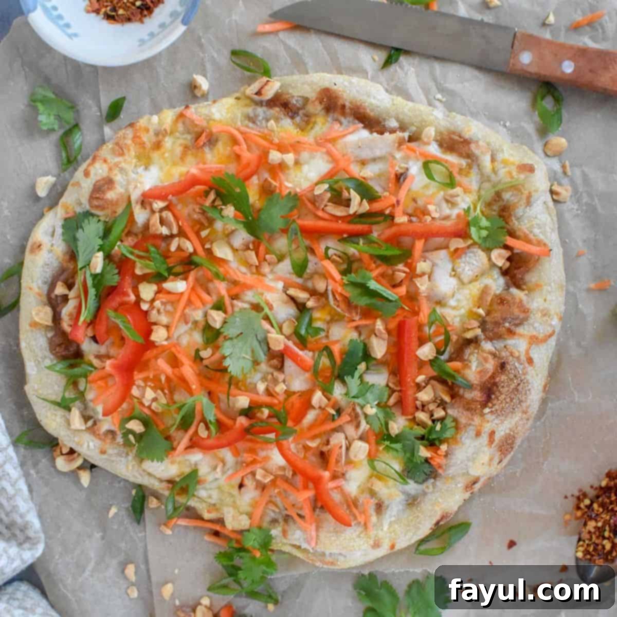 Thai Chicken Pizza, featuring a vibrant blend of sweet and savory toppings with fresh vegetables.