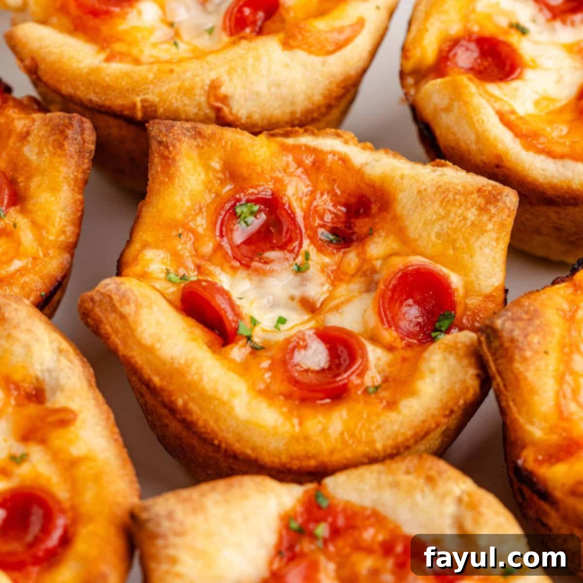 Mini Pizza Cups, baked in a muffin tin, showing their crispy, cheesy, bite-sized appeal.