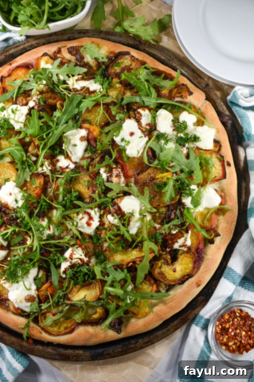Summer Grilled Peach and Goat Cheese Pizza, featuring perfectly grilled peaches, tangy goat cheese, caramelized leeks, and fresh herbs on a homemade crust.