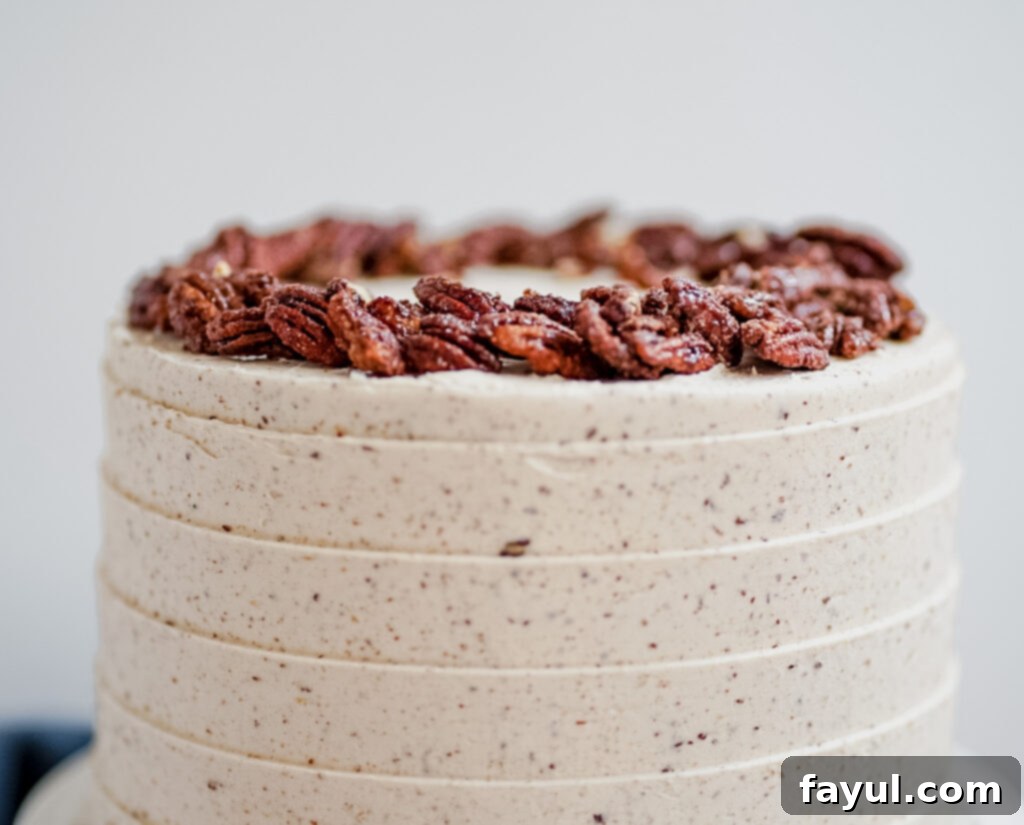 A generous pile of golden-brown maple candied pecans, glistening with their sweet, crunchy coating.