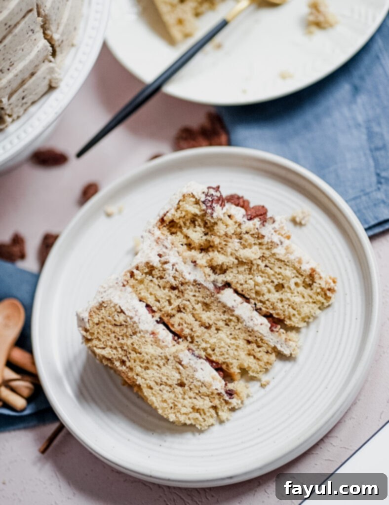 A beautifully decorated Maple Pecan Cake, garnished with whole candied pecans, showcasing its rich texture and festive appearance.