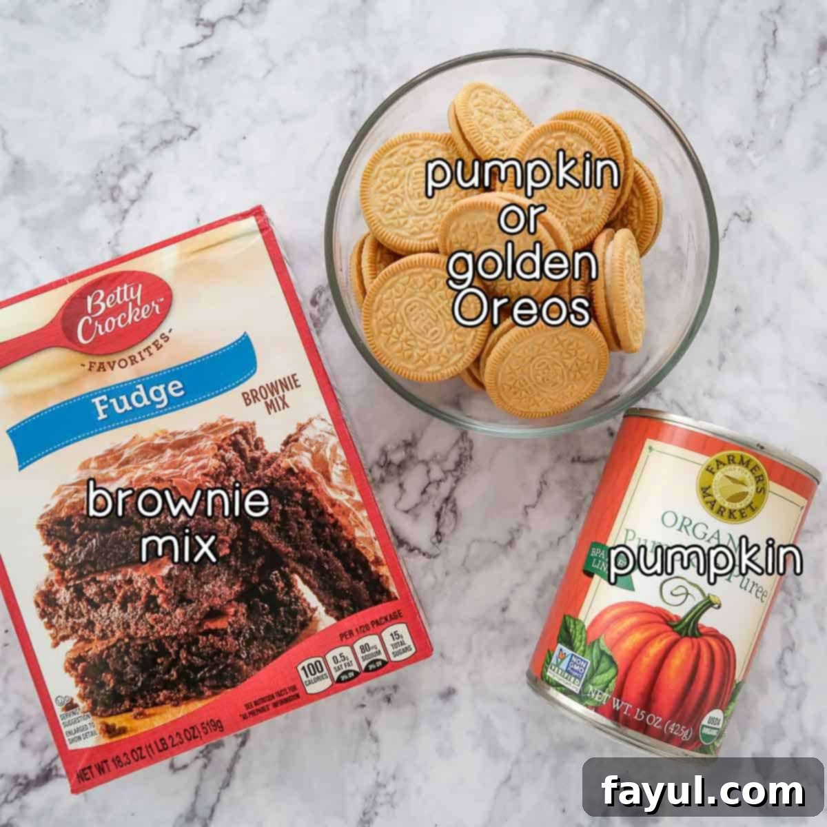 Overhead shot of brownie mix, canned pumpkin puree, and a package of pumpkin Oreos, the three simple ingredients for these brownies.