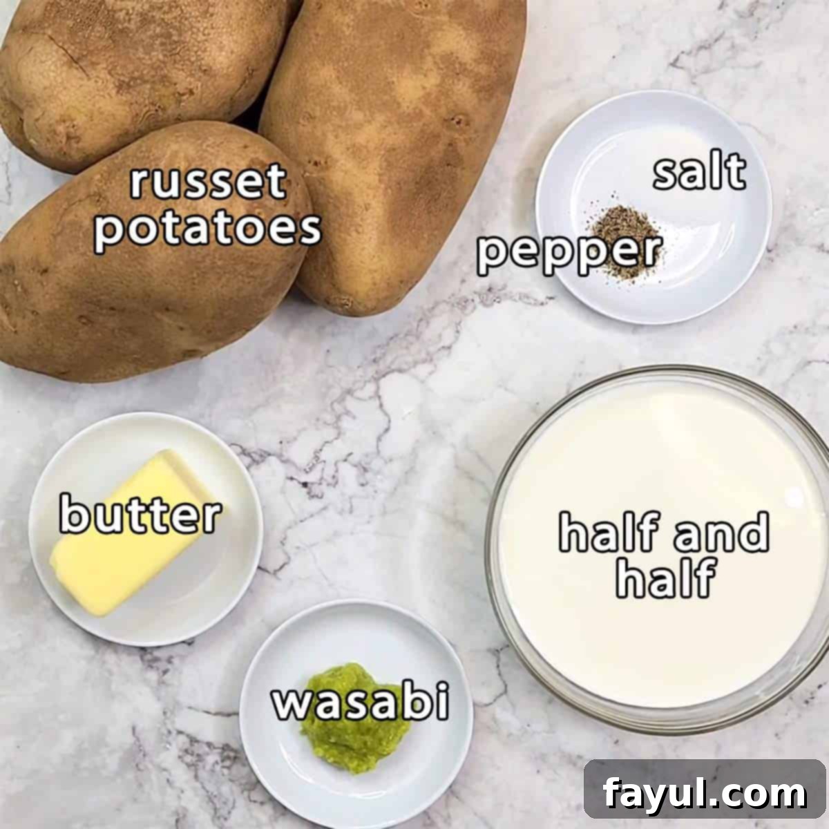 Overhead shot of ingredients - russet potatoes, half and half, butter, wasabi, salt, and pepper.