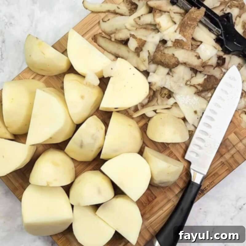 Overhead view of process shot 1 - peel the potatoes and cut into chunks.