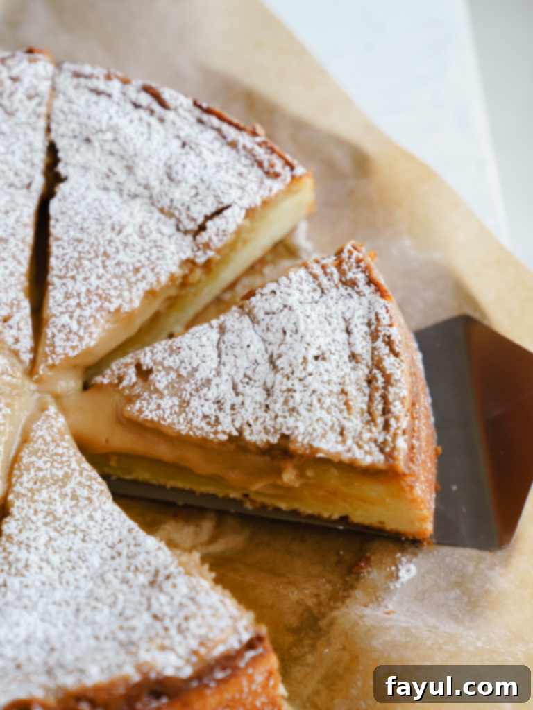 Slice of Caramel Gooey Butter Cake with powdered sugar