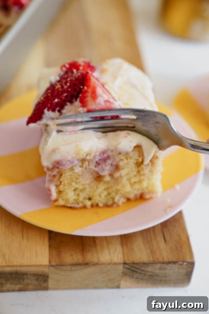 Strawberry Poke Cake with moist cake, strawberry sauce, and creamy frosting